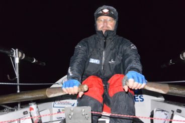 Huw rowing at night in the rain