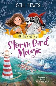 Image of an illustrated book cover showing a child and a large shaggy dog standing together in the middle of the image. The child holds a small bird gently in their hands while the dog, wearing a red bandana and an eye patch, looks to the reader. White swirling lines around them create a sense of wind or magic. Below them is an illustrated coastal village with red‑roofed houses, green fields, and a tall red‑and‑white lighthouse standing near the shoreline. At the top, the text reads “GILL LEWIS,” and beneath it a ribbon banner says “THE ISLAND VET.” The title “Storm Bird Magic” appears in large purple script. At the bottom right, the illustrator credit reads “Illustrated by Irina Avgustinovich.”