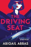 Image of a book cover featuring bold, graphic artwork in deep navy, red, and purple tones. A stylised woman wearing red sunglasses appears in the upper half of the image. Below, a winding road stretches diagonally across the cover, with a small car shown traveling along it. Mountains or hills in dark silhouettes flank the road. The title “THE DRIVING SEAT” is displayed in large red uppercase letters across the middle of the book. At the bottom, the author’s name, “ABIGAIL ABBAS,” appears in white text.