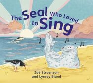 Image of a book cover showing a brightly illustrated seaside scene. A light grey seal sits upright on a sandy beach, facing the viewer, with its mouth open as musical notes float upward. A bird stands nearby on the sand. Behind them, the ocean stretches out with waves and a distant shoreline. The sky is filled with soft pastel clouds and rays of sun near the horizon. The title “The Seal Who Loved to Sing” curves across the top in indigo lettering. At the bottom, the authors’ and illustrators' names, “Zoë Stevenson and Lynsey Bland,” appear in dark blue text.